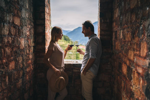 They look outside window toward vineyard and cheers in celebration