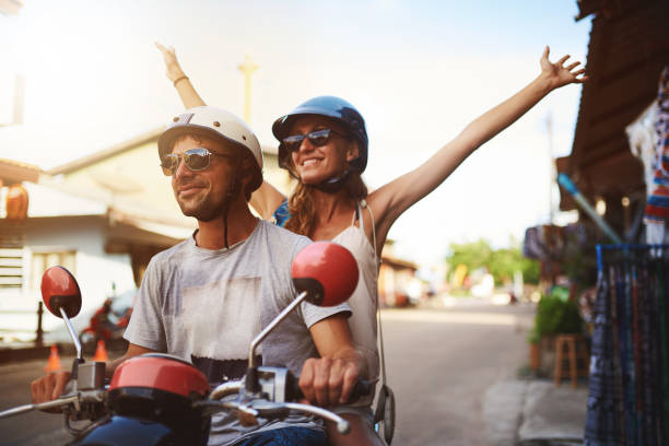 Shot of young tourists enjoying a scooter ride around the city